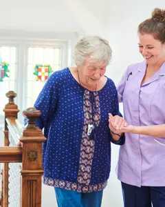 Caregiver smiling with senior woman