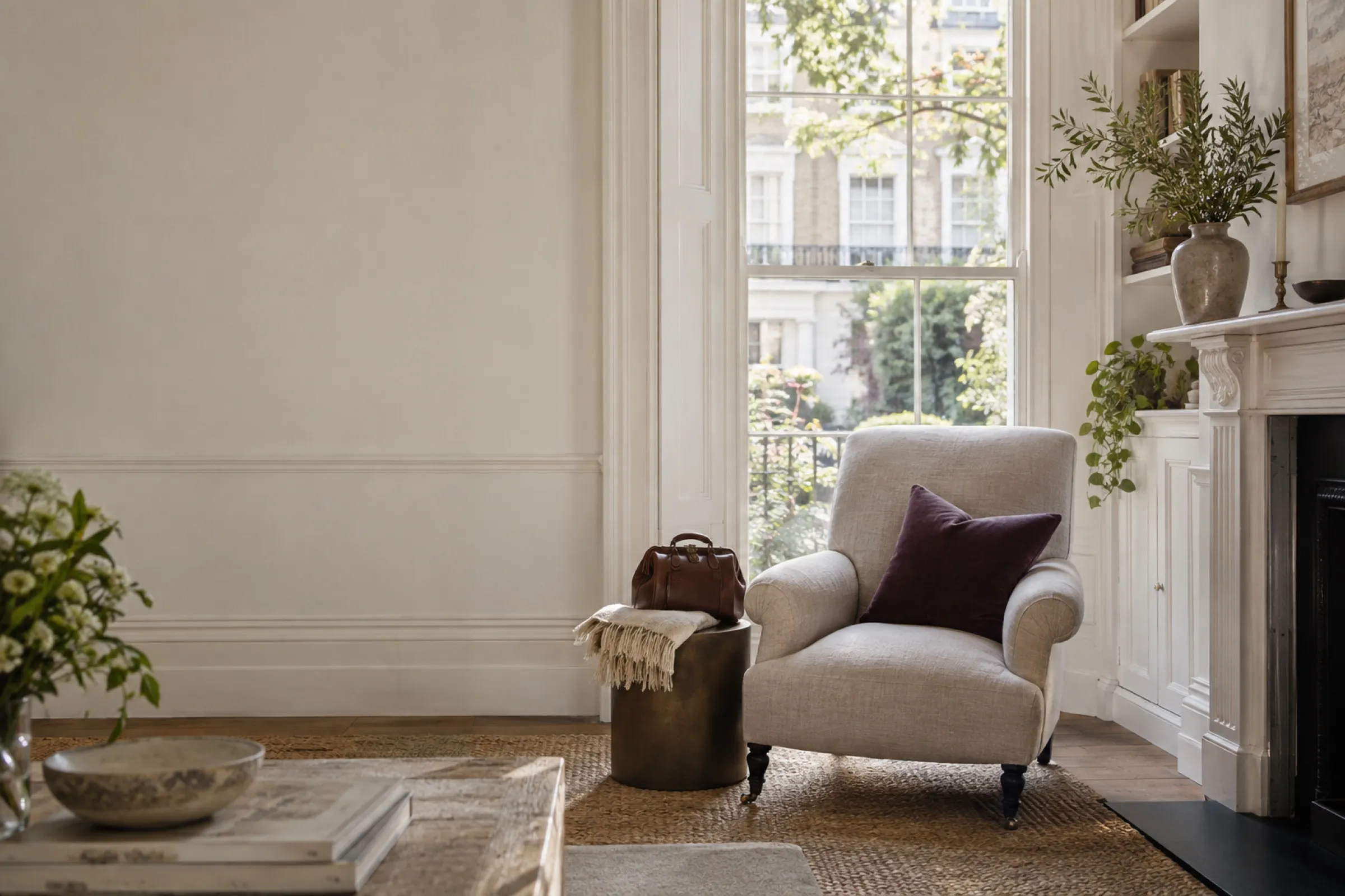 A quiet London sitting room in morning light, an armchair by a tall sash window